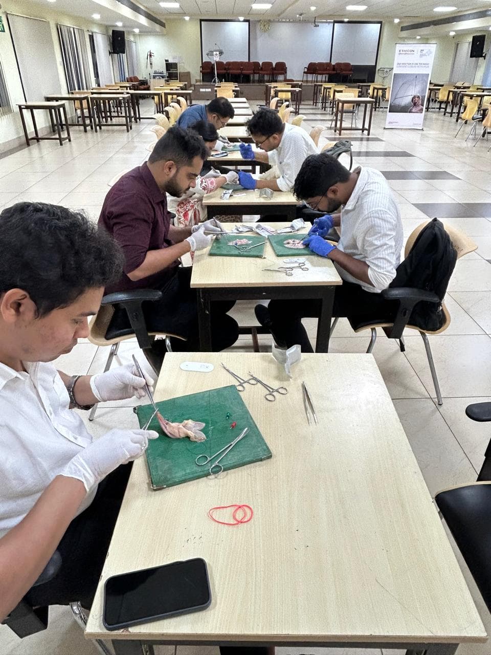 Hands practicing vascular anastomosis technique